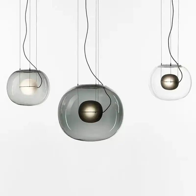 Modern glossy black glass ball pendant light with translucent gray shades and metallic gold inner spheres for dining room decorbites brokis big