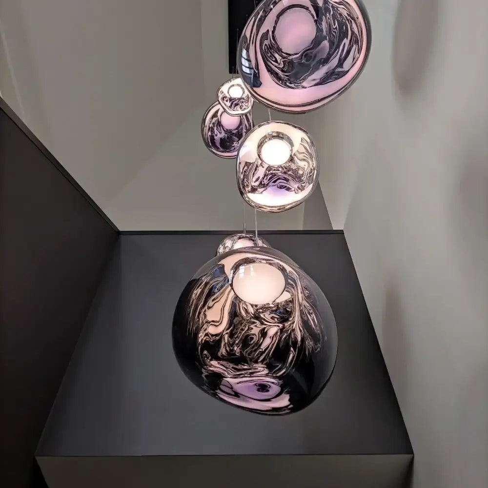 A modern multi-tiered pendant light with glossy copper glass lava led spherical shades for living room decorbites glass lava