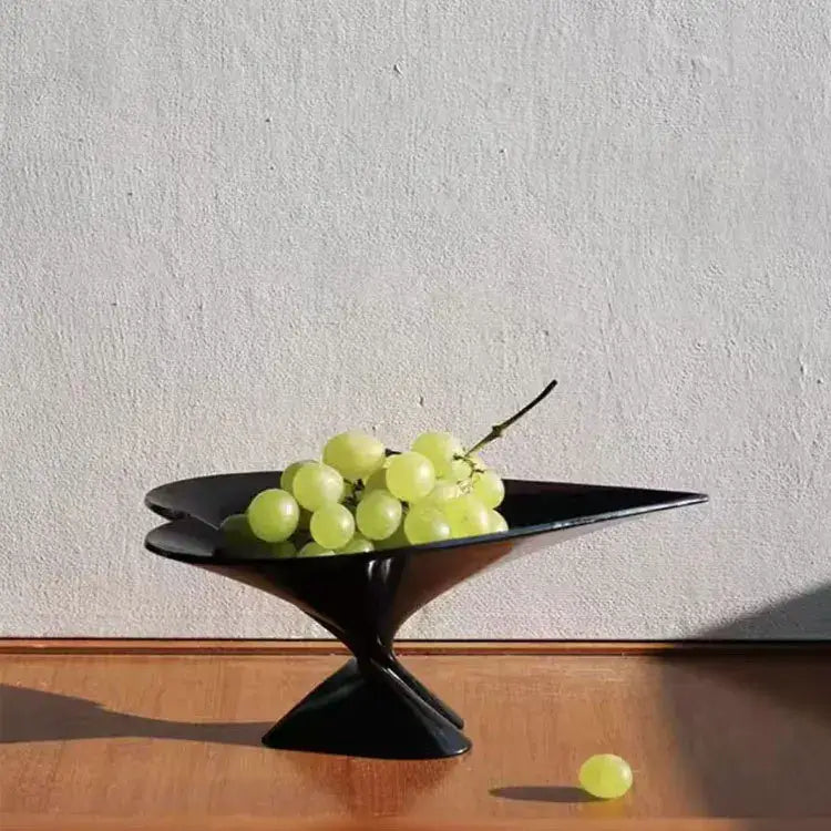 Black ceramic decorbites geometric fruit plate with glossy green leaf design holding green grapes for fruit plate jewelry use