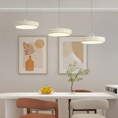 Three modern glossy pale yellow circular dimmable pendant lights with off-white ceramic shades for dining room decorbites circular dimmable