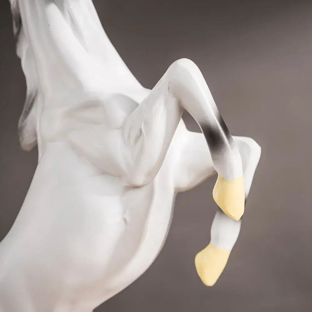 A sleek white ceramic decorbites horse statue with black and yellow accents for modern living room decor