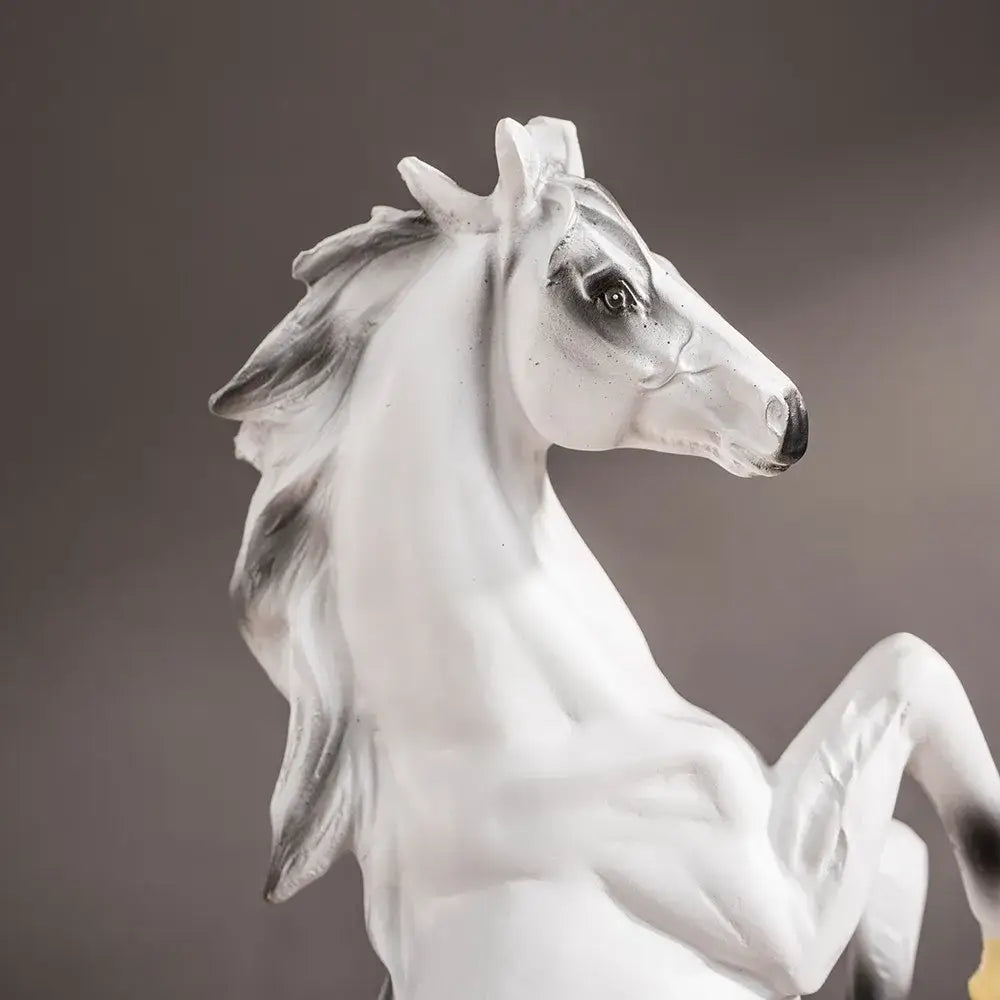 A sleek white glossy resin horse statue with gray shading in a poised rearing stance for modern living room decorbites horse statue