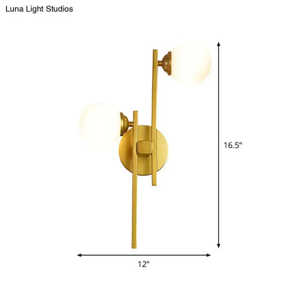 Modern gold wall lamp with two frosted glass spherical shades for living room light type illumination