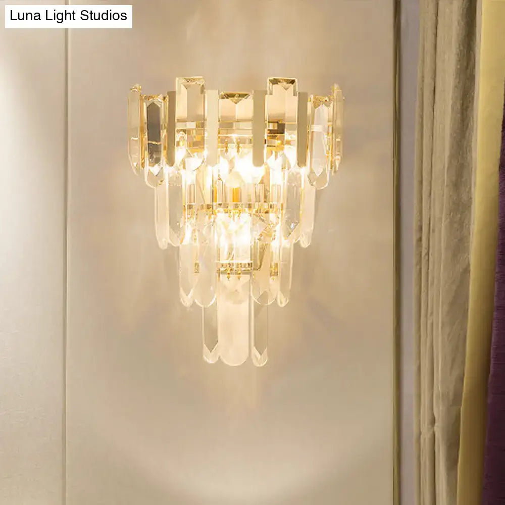 Modern gold 3-headed tiered crystal wall sconce with clear glass prisms and gold-toned metal 15 inch fixture