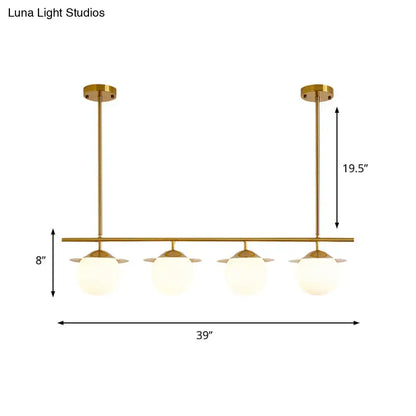 DecorBites gold opal glass round island pendant light with four frosted glass globes in a modern gold-toned finish