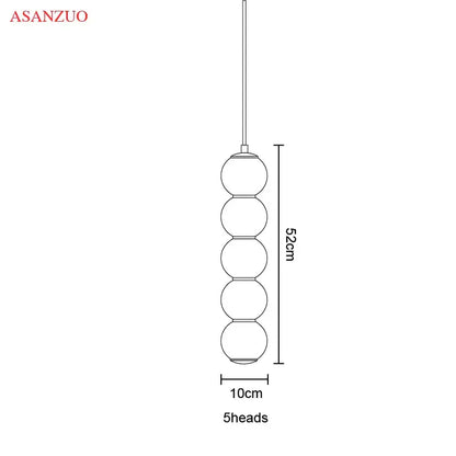 Modern gold asanzuo pendant lights featuring five vertically stacked spherical glass ball pendant globes for dining decorbites