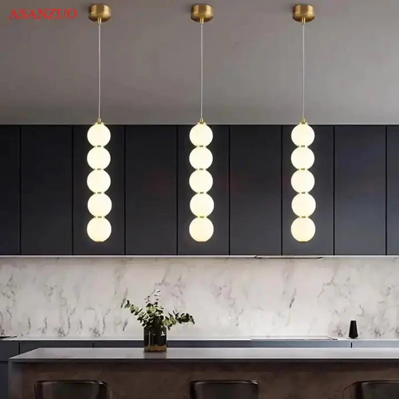 Modern gold 5-sphere glass ball pendant lights featuring a vertical cascade of frosted glass spheres for dining room decorbites glass ball pendant