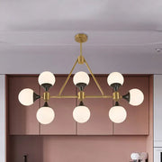 Modern gold decorbites metal chandelier with six frosted glass globe shades and black accents for island lighting