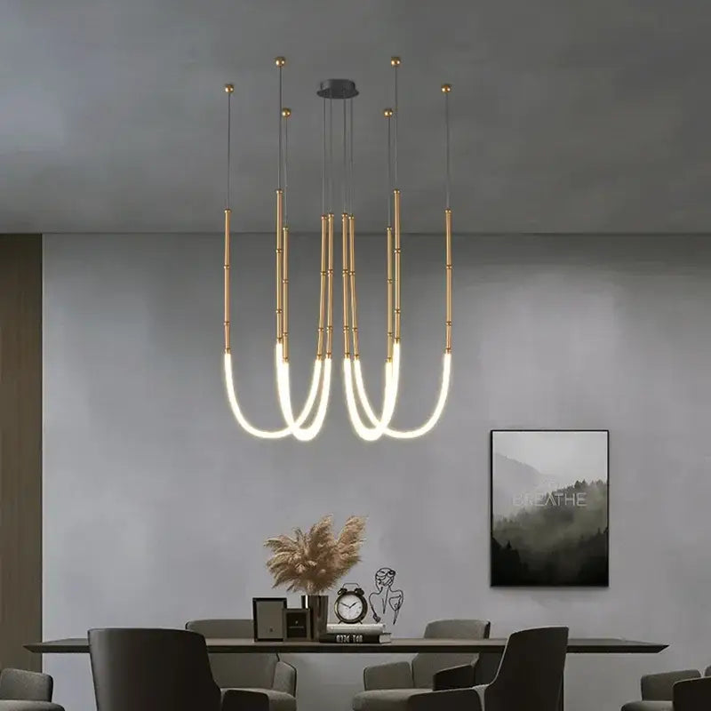 Modern gold acrylic bamboo pendant light with brushed nickel finish and curved illuminated arms for dining room