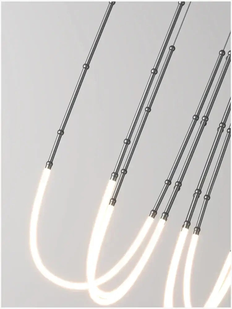 Modern gold acrylic bamboo pendant light with brushed nickel finish and sleek metallic rods for dining room lighting