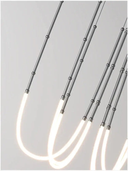 Modern gold acrylic bamboo pendant light with brushed nickel finish and sleek metallic rods for dining room lighting