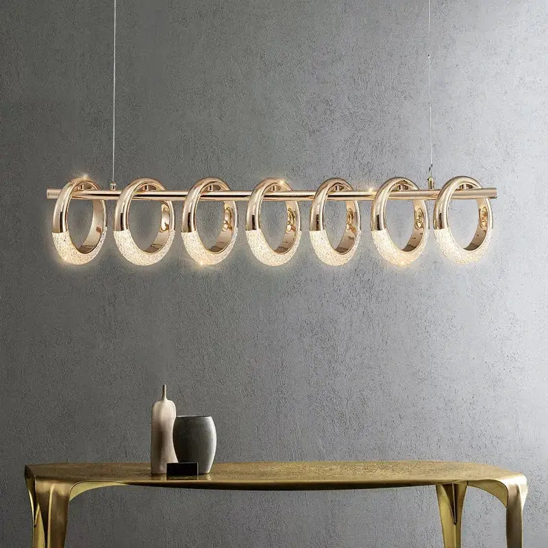 Modern gold acrylic led pendant lights with seven glowing circular rings for dining room illumination