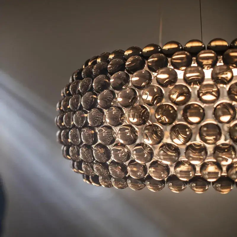 Modern gold acrylic rs7 bulb pendant lights with dark amber glass orbs for elegant dining room decorbites acrylic rs7 bulb chandelier