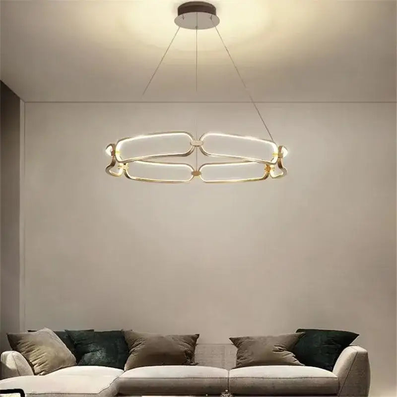 Modern gold adara luxury led chandelier with sleek interconnected oval rings and minimalist circular ceiling mount for dining room