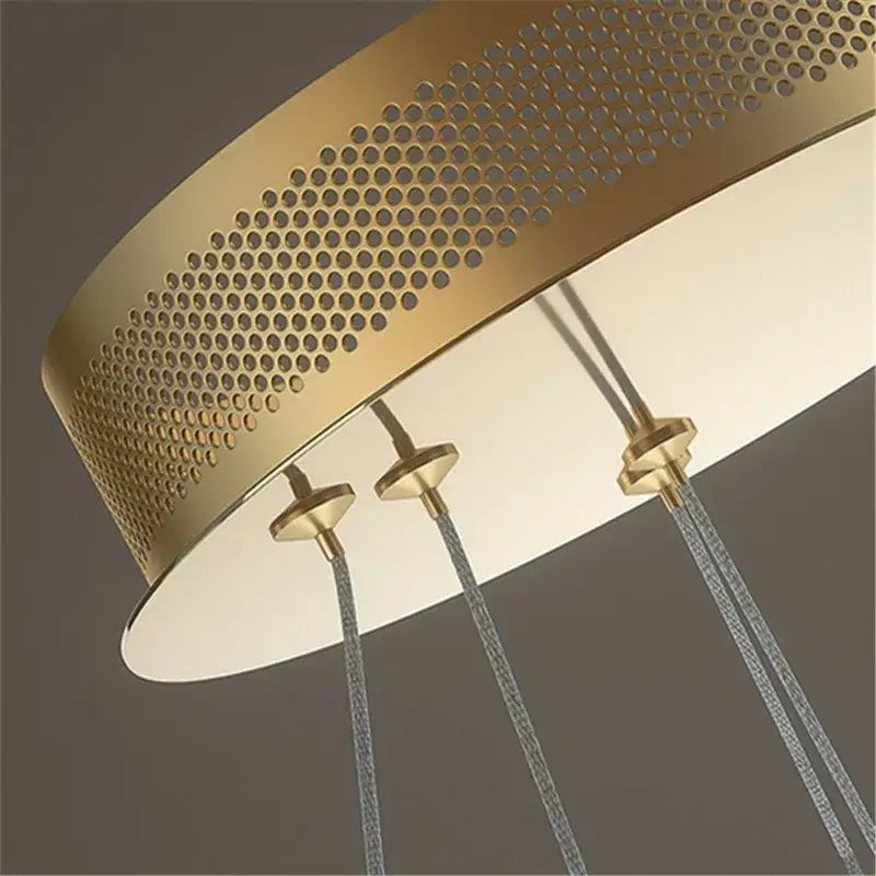 Modern gold adara luxury led chandelier features a gold-toned perforated metal pendant with three hanging cords for dining room decorbites adara luxury
