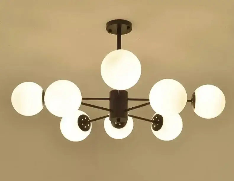 Modern black metal chandelier with frosted white glass globes featuring decorbites adjustable ball glass lustre design