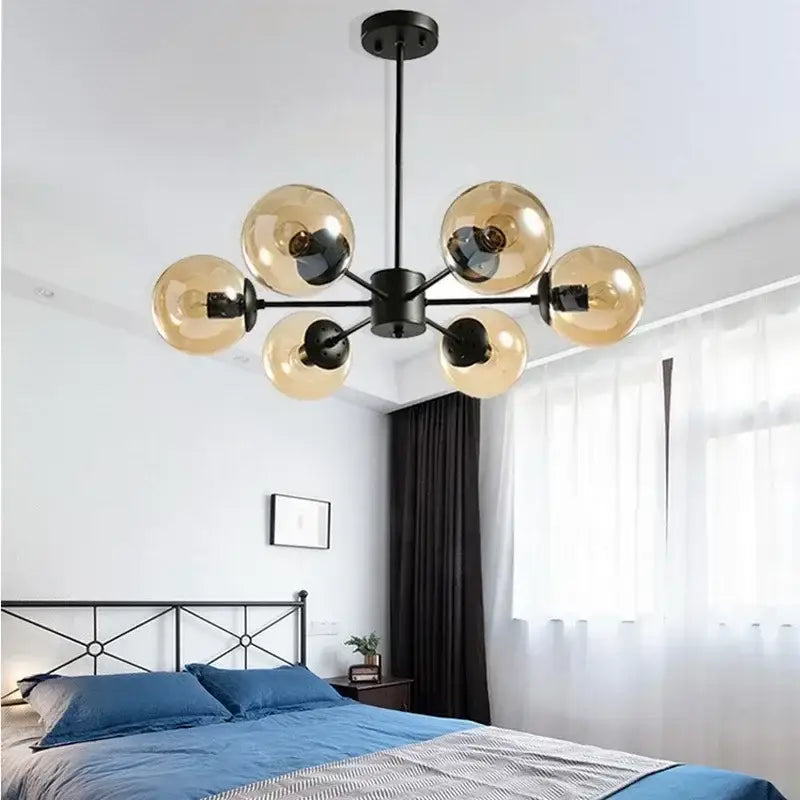 Black metal chandelier with six amber glass globe shades for dining room featuring decorbites adjustable ball glass lustre