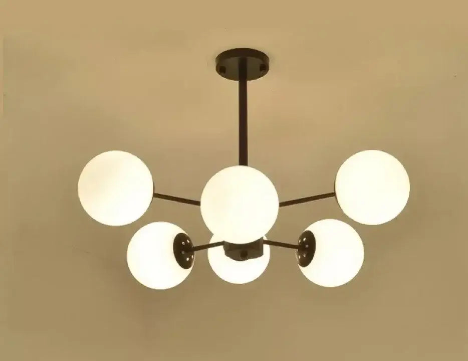 Modern black metal chandelier with five frosted glass globes featuring decorbites adjustable ball glass lustre design