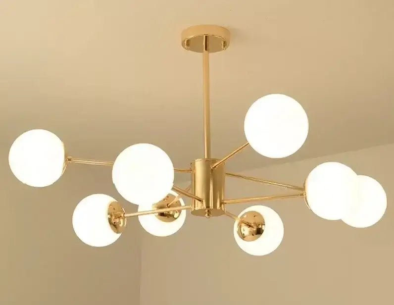 Modern gold adjustable ball glass lustre featuring multiple frosted globe bulbs in a branching dining room design