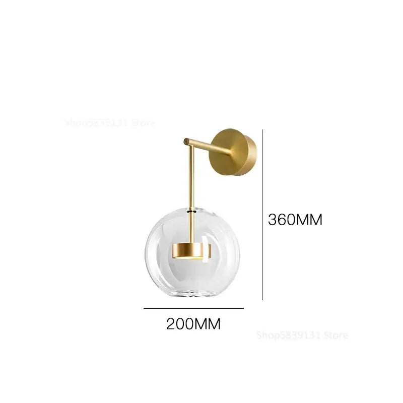 Modern gold adjustable direction wall lamp with gold-toned metal and clear glass globe for stylish bedroom wall light decorbites