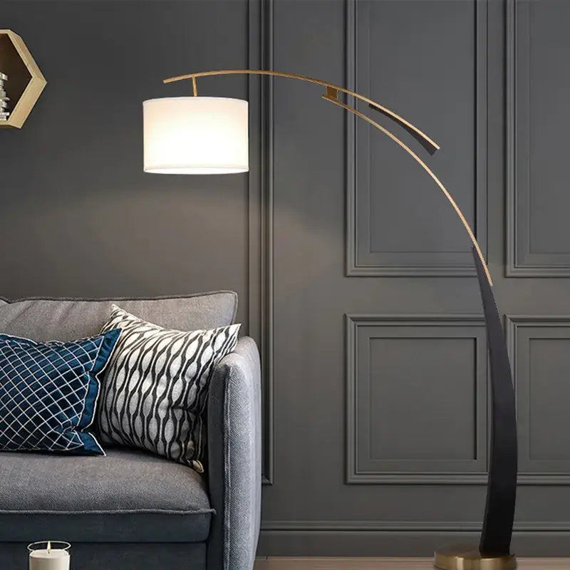 A sleek curved gold-toned decorbites adjustable metal floor lamp with a white cylindrical shade for living room decor