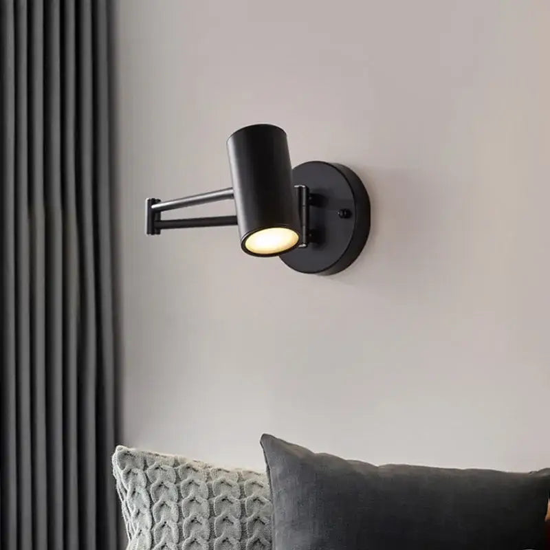 Black matte adjustable swing arm wall lamp with cylindrical head ideal for modern bedroom reading light