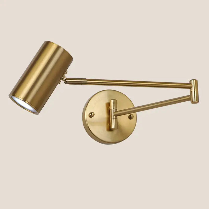 Brass-finished modern gold wall lamp with adjustable swing arm and cylindrical head for bedroom reading light