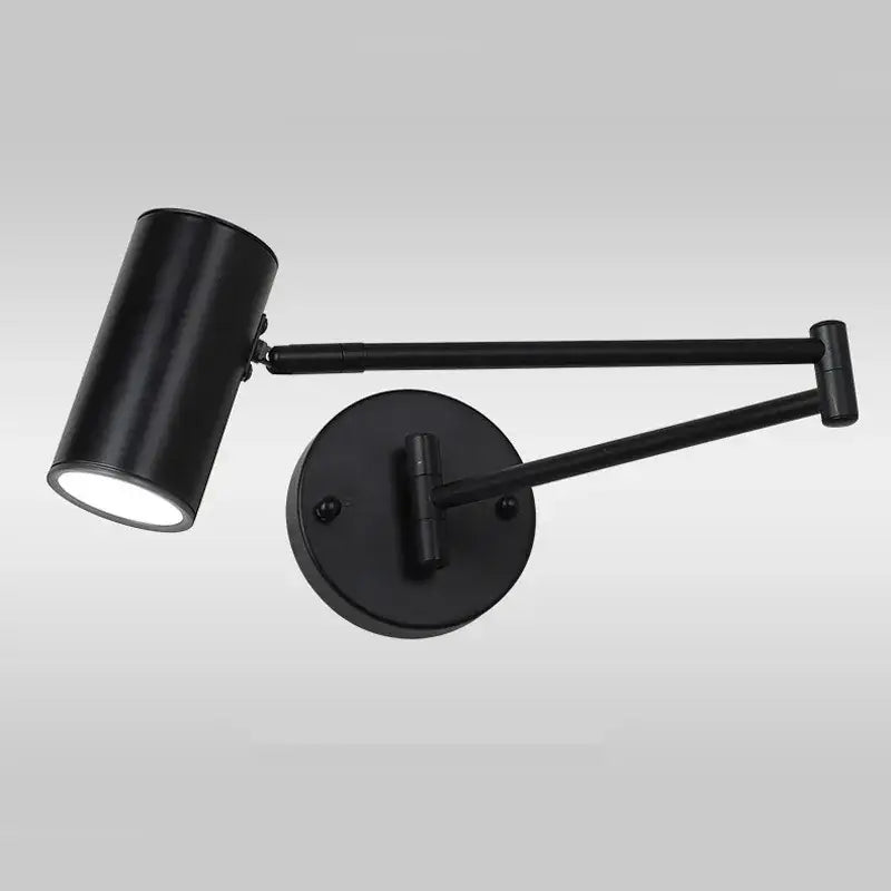 Black matte adjustable swing arm wall lamp with cylindrical head and articulated arms for bedroom reading light