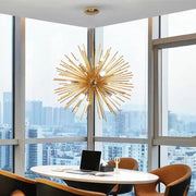 Modern gold aluminum dandelion pendant light with slender metallic rods radiating from a central hub for dining room
