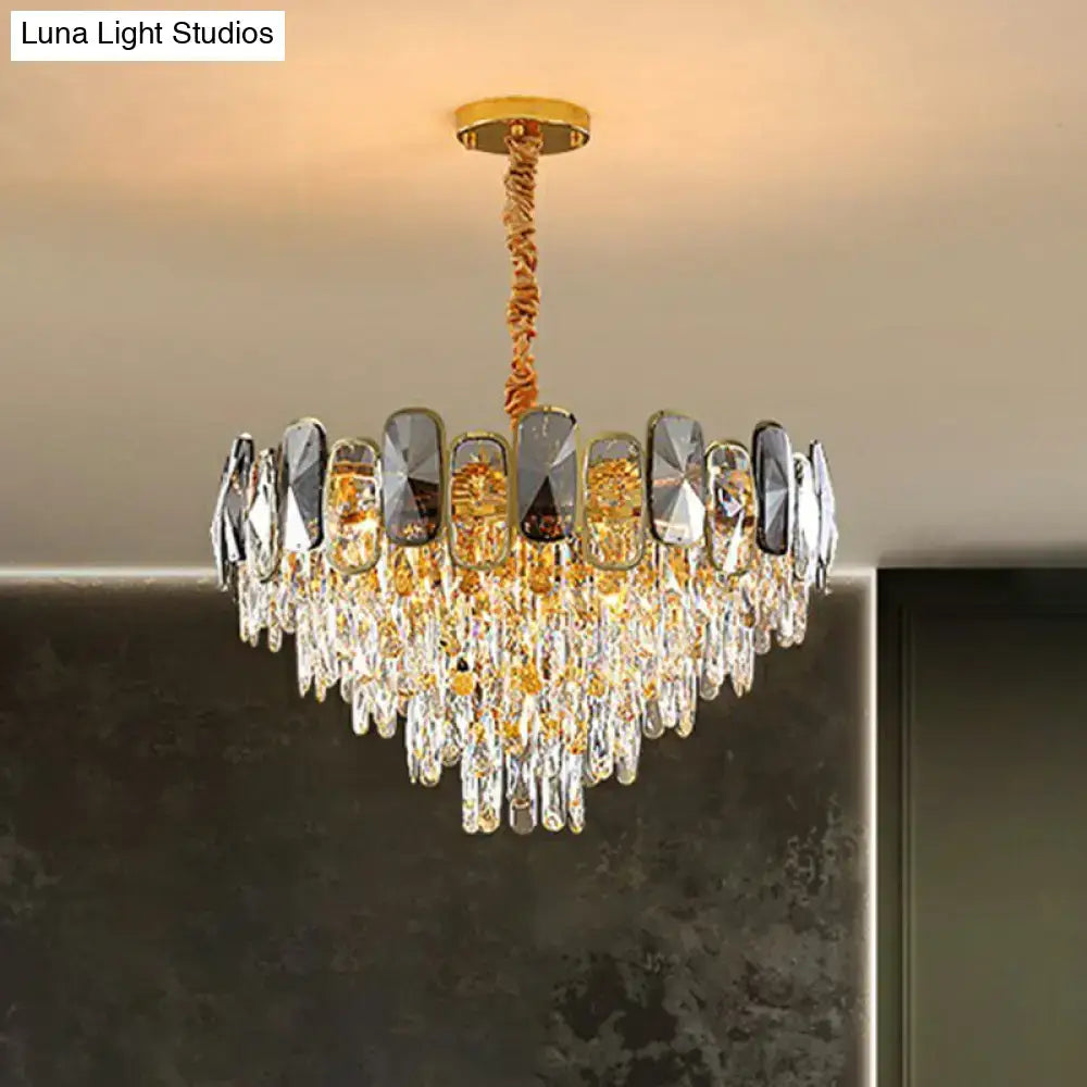 A luxurious gold-toned crystal cone chandelier with clear and amber crystals and mirrored panels for living room lighting