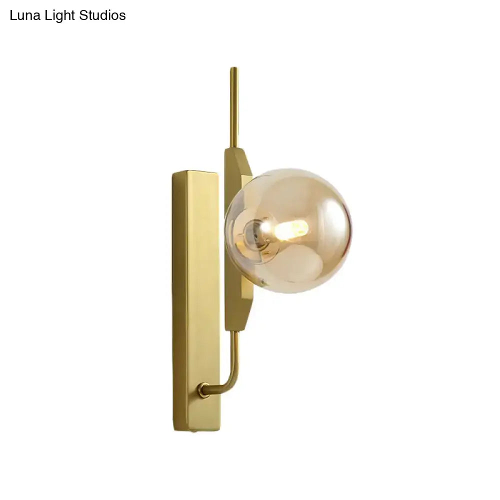 Modern gold and amber glass orb wall light fixture with sleek rectangular backplate for bedroom 110v-120v use