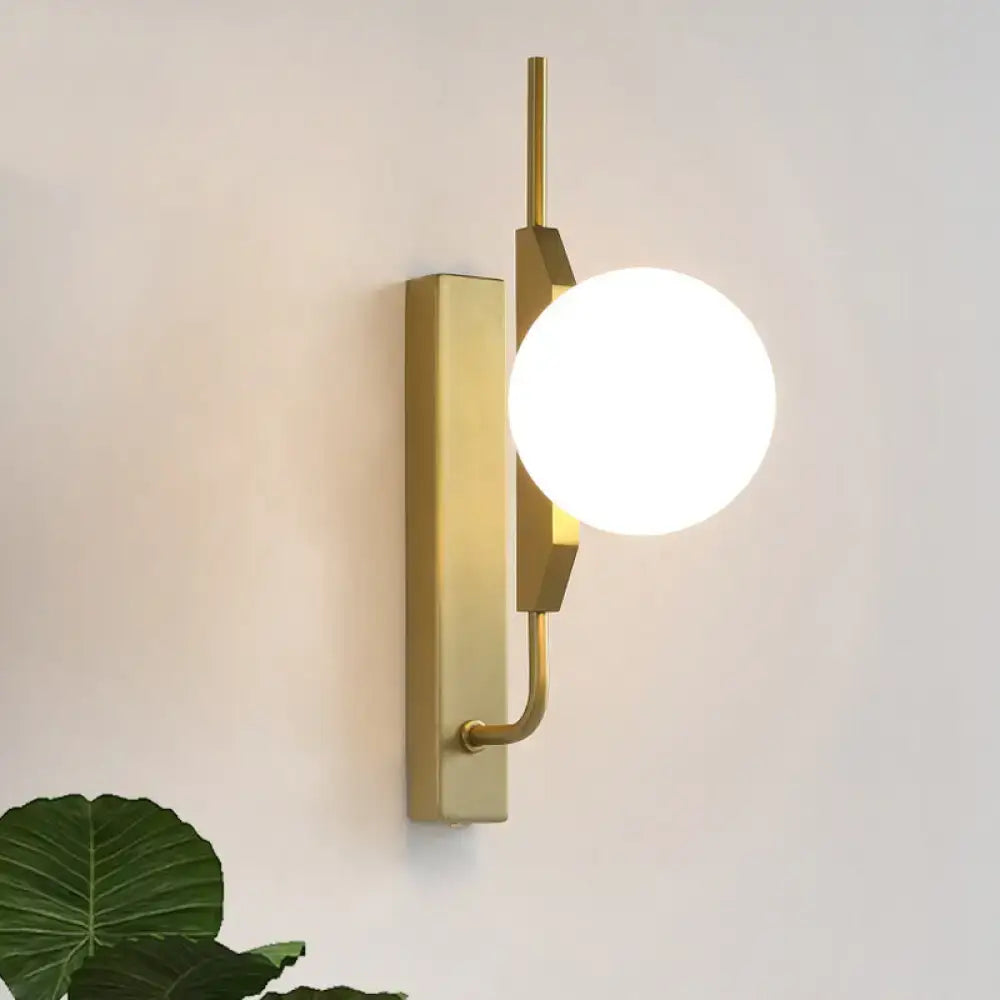 Modern gold and amber glass orb light fixture with frosted globe and sleek rectangular base for 110v-120v use