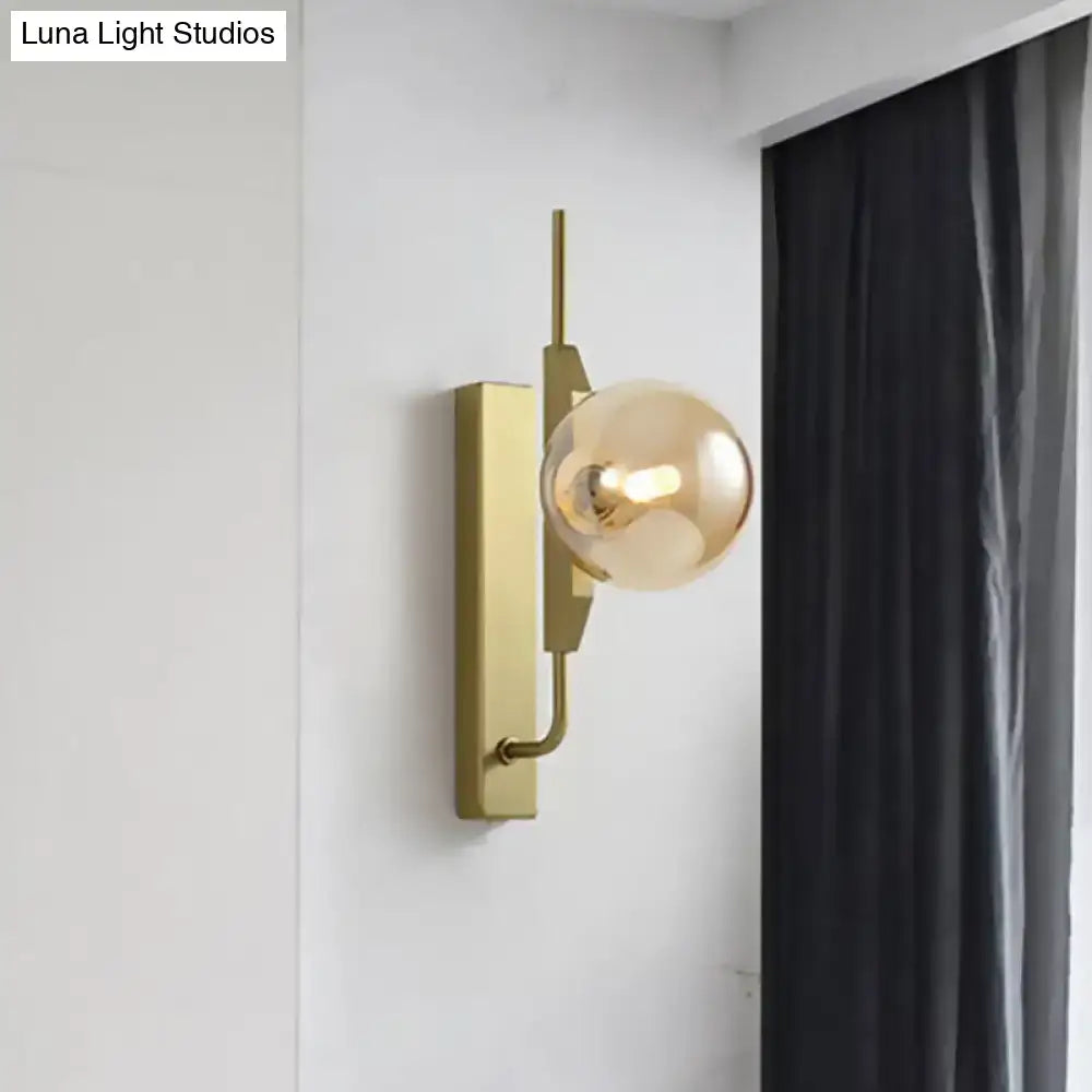 Modern gold and amber glass orb wall light fixture with geometric metal frame for bedroom 110v-120v use
