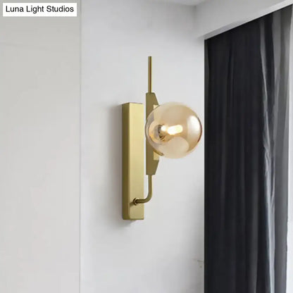 Modern gold and amber glass orb wall light fixture with geometric metal frame for bedroom 110v-120v use