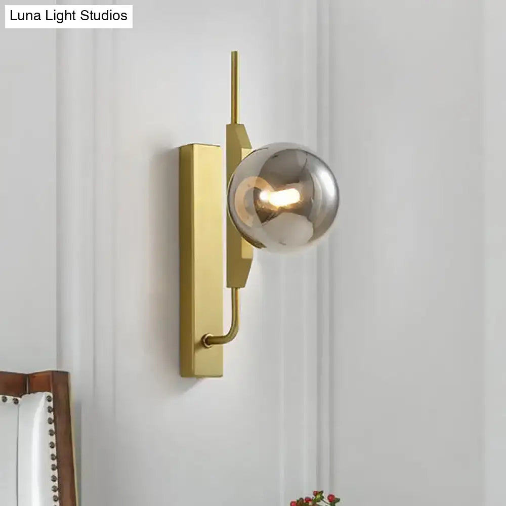 Modern gold and amber glass orb light fixture with sleek geometric backplate and silver glass globe for 110v-120v use