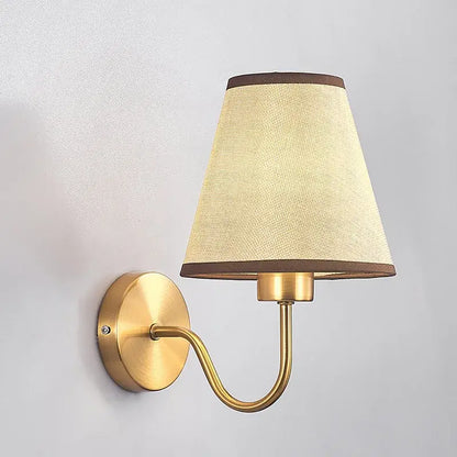 Modern gold and beige cloth led wall lamp with brass finish and beige textured fabric shade with dark brown trim decorbites cloth led