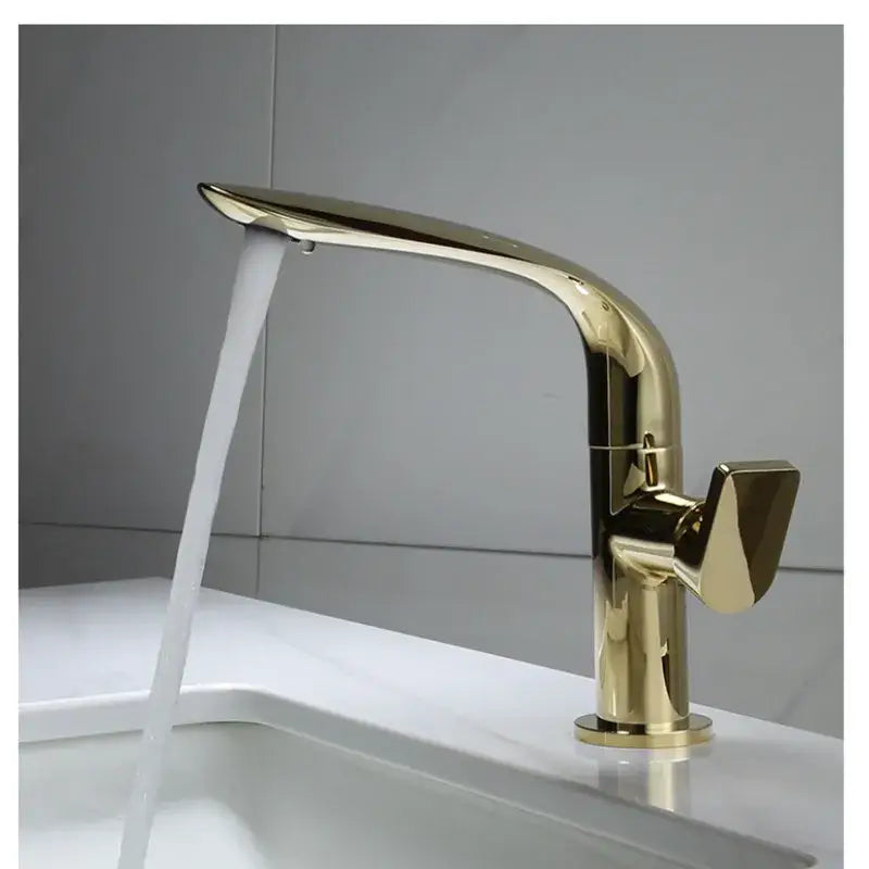 Modern gold and black decorbites basin faucet with sleek curved spout and angular handle for bathroom use
