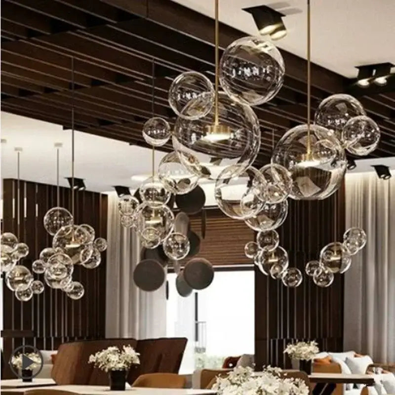 Modern gold and black glass chandelier with clear bubble glass and gold-toned metal by decorbites glass chandelier
