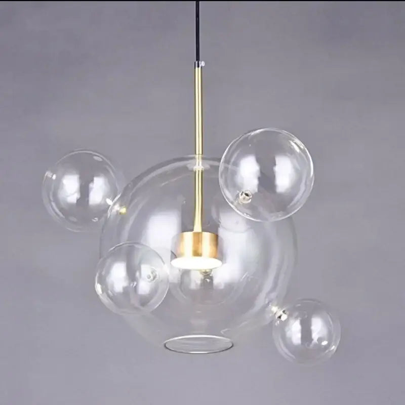 Modern gold and black glass chandelier with clear glass bubble pendant and brass-finished rod by decorbites glass chandelier