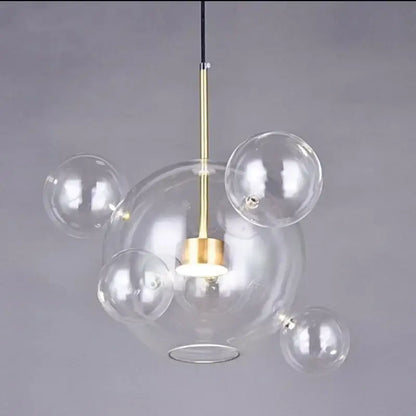 Modern gold and black glass chandelier with clear glass bubble pendant and brass-finished rod by decorbites glass chandelier