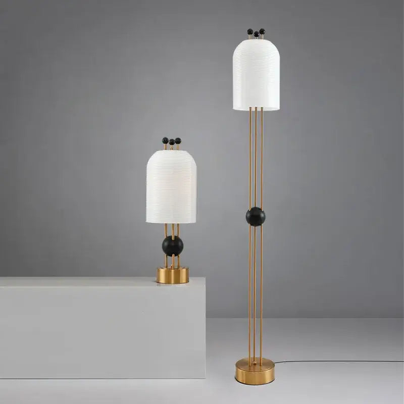 Modern floor lamp with white ribbed paper shade and gold metal frame accented by black beads for glass led chandelier decor
