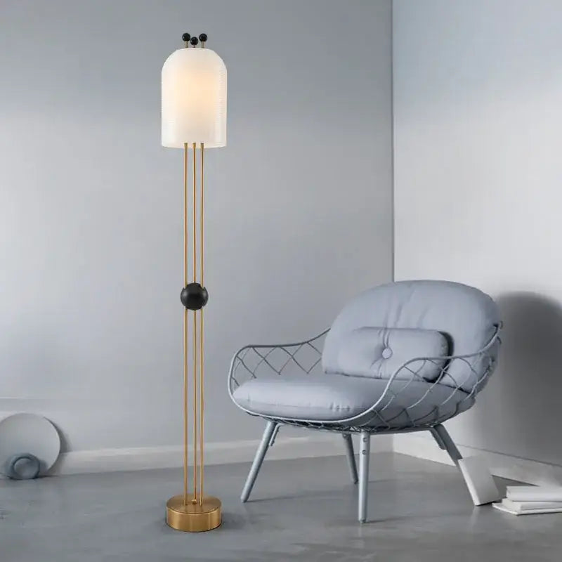 Modern gold and black glass led chandelier with a gold-toned floor lamp and frosted dome shade featuring black accents