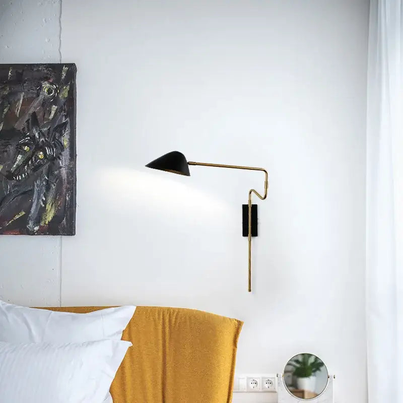 Black conical shade led wall lamp with a slender gold-toned articulated arm for modern bedroom lighting