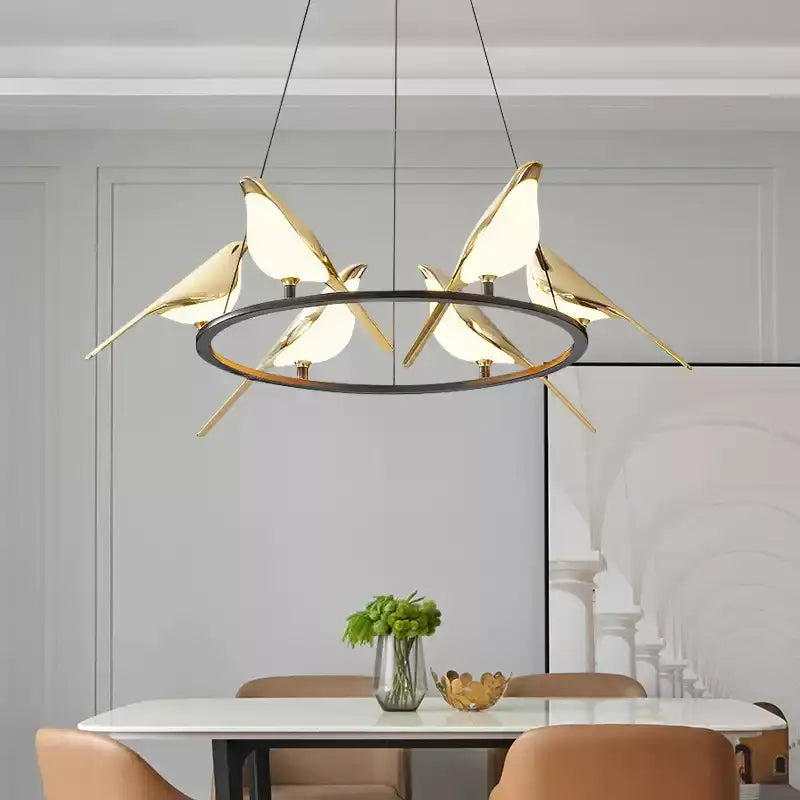 Modern gold and black magpie bird pendant light with translucent glass bodies and iron finish cord pendant installation