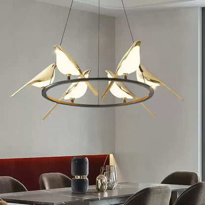 Modern gold and black magpie bird pendant light with illuminated translucent wings and iron finish for dining room cord pendant installation