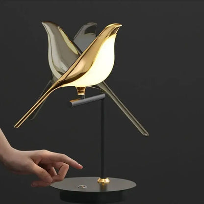 Modern gold and black magpie bird pendant light with sleek iron finish and cord pendant installation in dining room