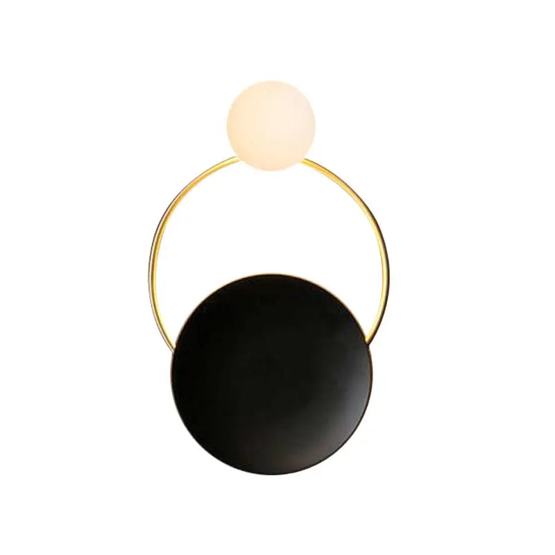 Modern gold and black orb wall lamp with a sleek gold circular frame and illuminated frosted glass orb for living rooms