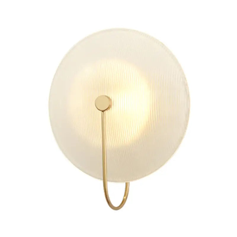 Modern gold and black orb wall lamp with frosted glass shade and slender brass frame for living room lighting