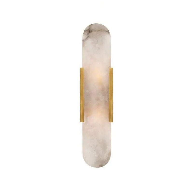 A sleek, elongated wall sconce with a soft white marble body accented by two vertical brass bars.