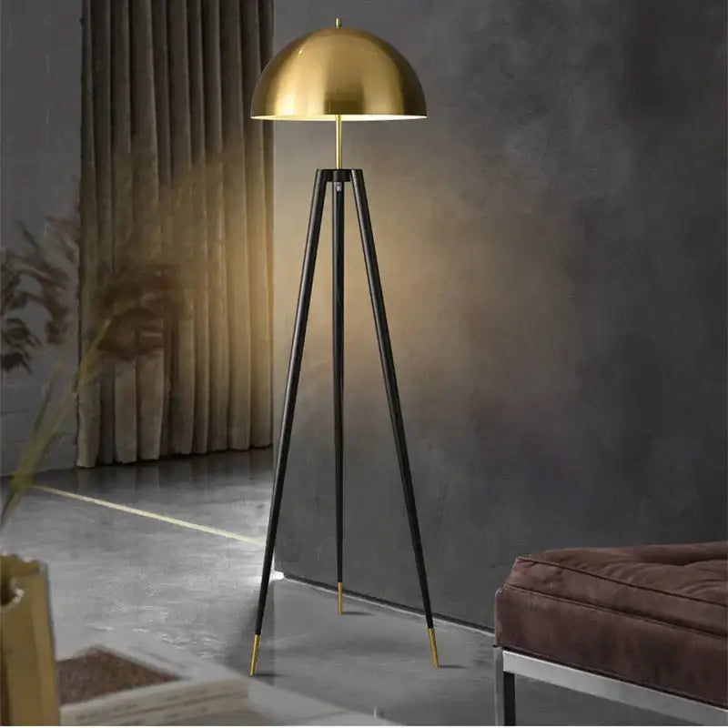 Modern gold and black decorbites coyote tripod floor lamp with gold dome shade and black tripod legs for living room decor
